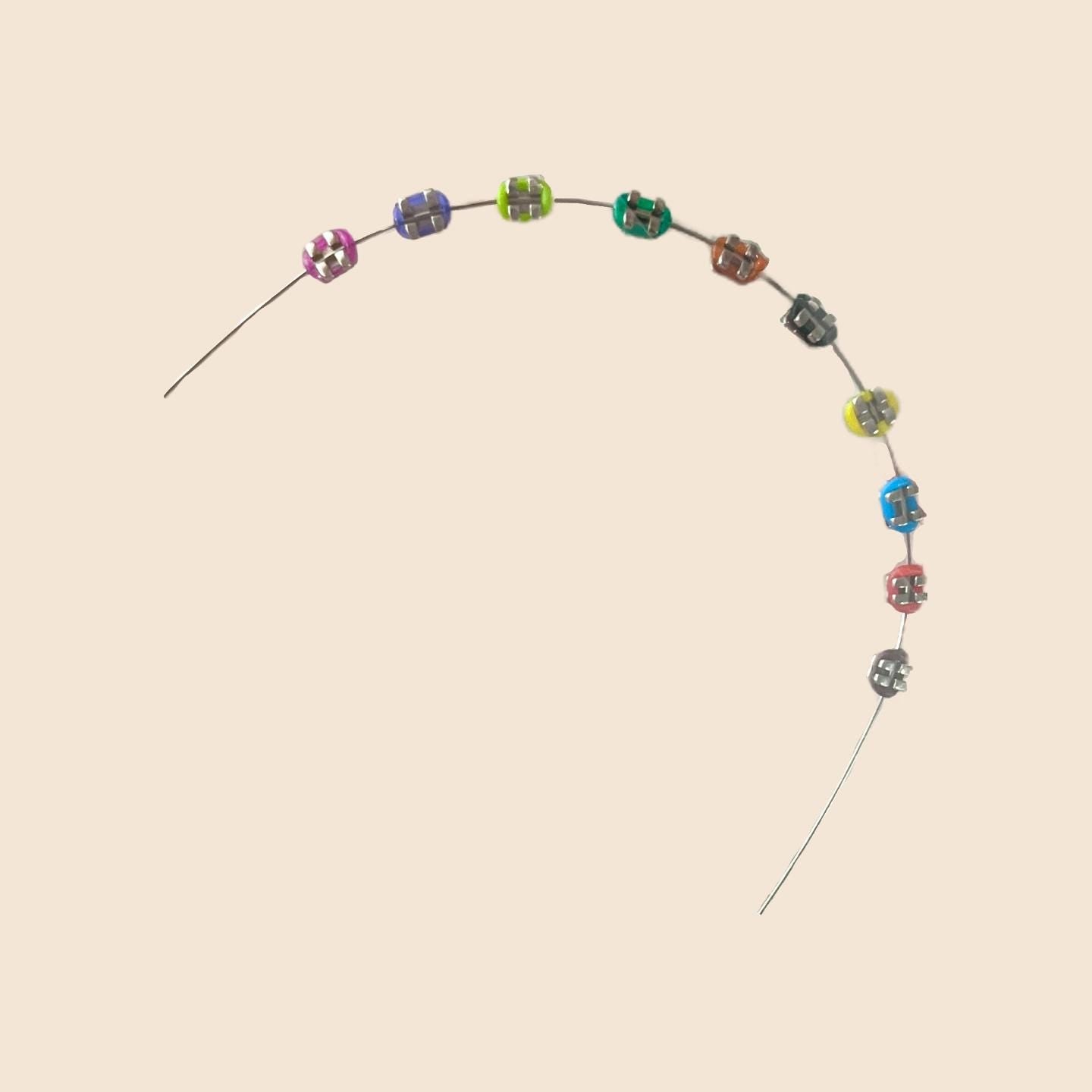 Colorful handmade doll braces variant with detailed colored brackets arranged on wire, part of a DIY cosplay accessory kit. Suitable forThe monster Labubu dolls. Doll not included.
