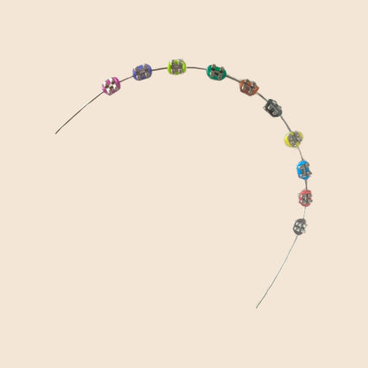Colorful handmade doll braces variant with detailed colored brackets arranged on wire, part of a DIY cosplay accessory kit. Suitable forThe monster Labubu dolls. Doll not included.