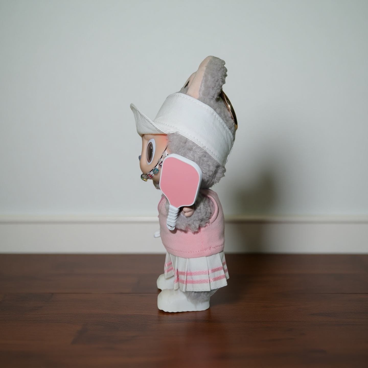 Side view of Labubu doll wearing pink pickleball outfit with paddle and cap, Popanion handmade design